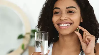 Smiling woman taking a natural supplement