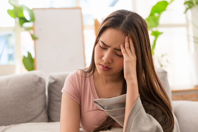 young woman holding her temple
